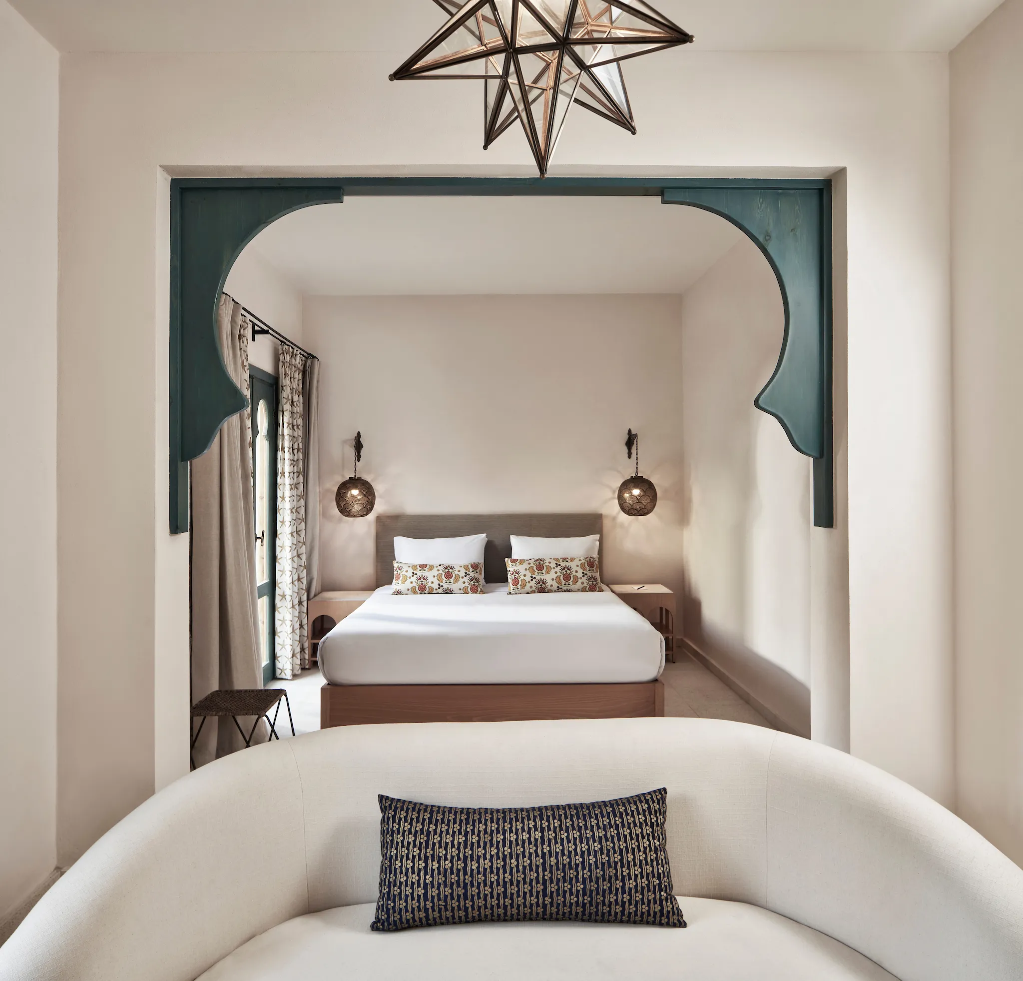 Junior Suite with double bed and sitting area framed by a decorative arch at Ali Pasha Hotel El Gouna