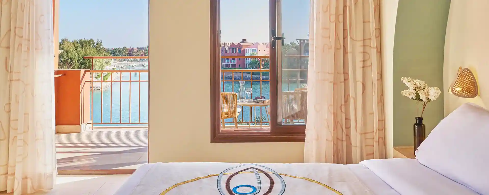 Room interior with open balcony offering a view of the lagoon below.