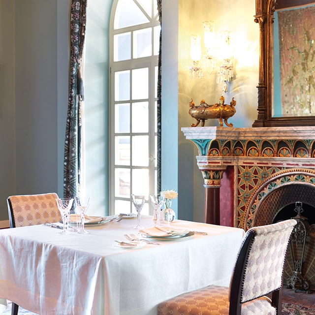 Charming dining table at La Maison Bleue el Gouna, complemented by a classic heater for a cozy dining experience.