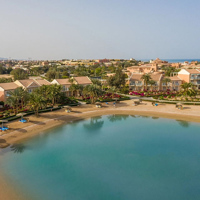 Lagoon side view with buildings and trees.