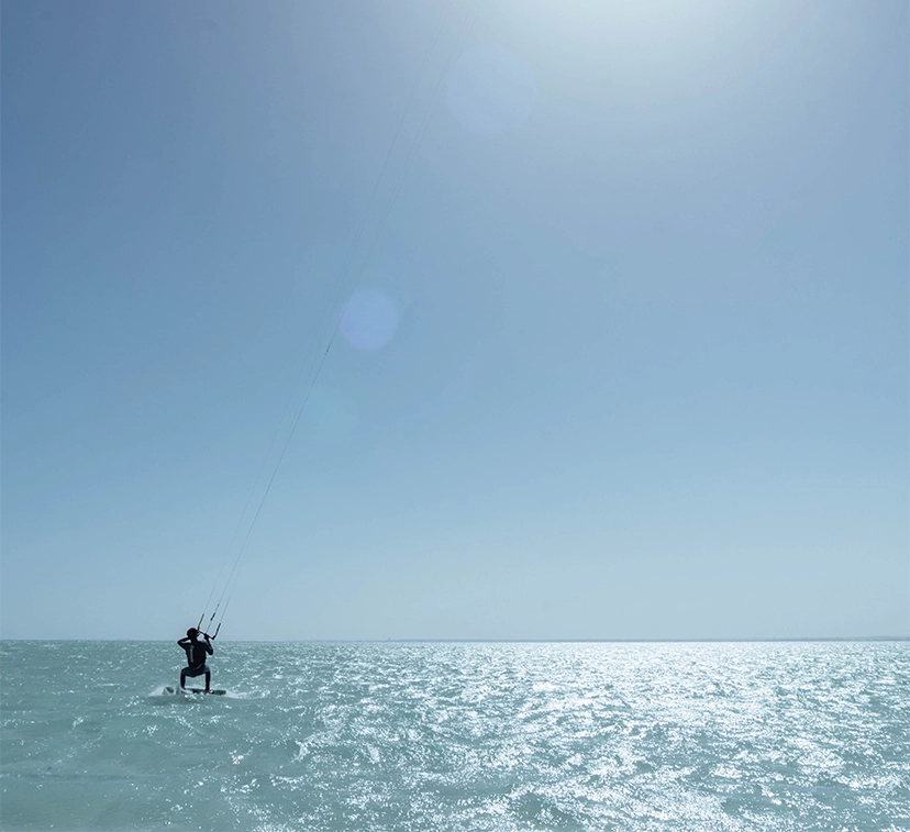 Kitesurfing in action, with the sea and sky as the backdrop.