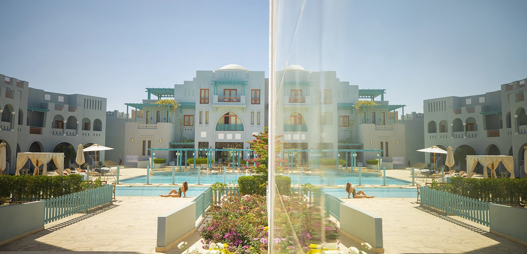 A woman sitting by the pool, enjoying the sun at Fanadir el Gouna.
