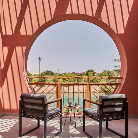 A terrace of a room at Steinberger Hotel, featuring outdoor seating with comfortable chairs and a table. The terrace offers a panoramic view of the surrounding landscape or garden. The space is decorated with potted plants and has a relaxing ambiance, ideal for enjoying the outdoors.
