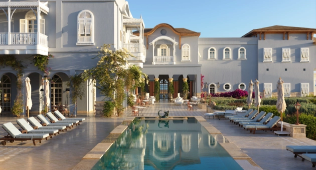 Tranquil poolside view at La Maison Bleue el Gouna, featuring the elegant architecture of the hotel in the background.