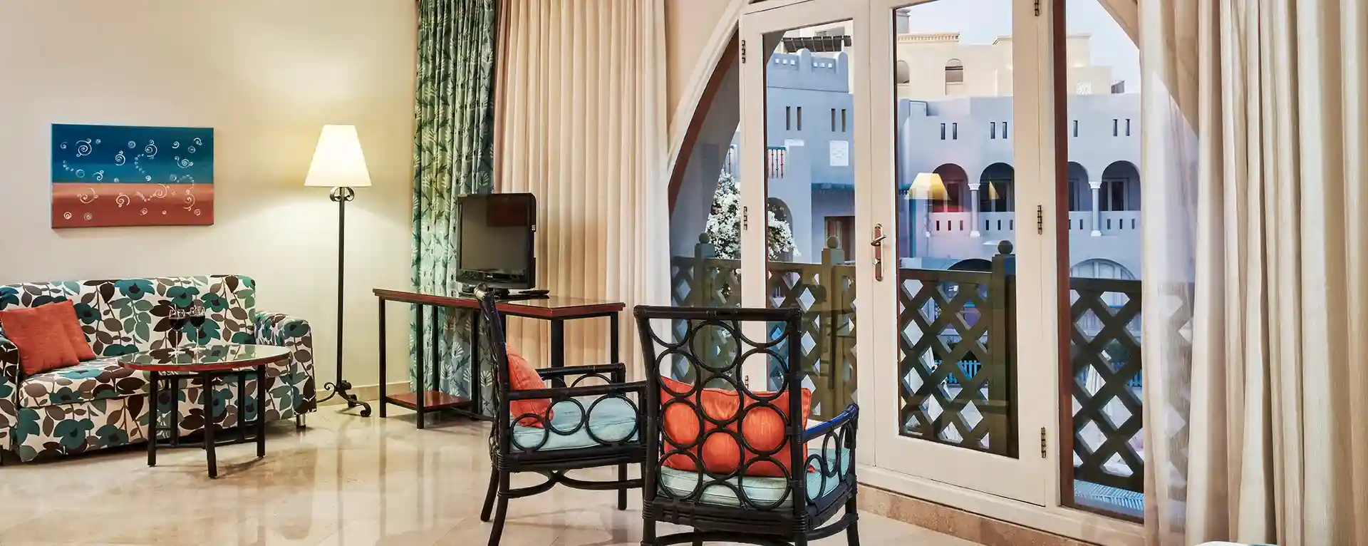A room at Fanadir el Gouna with open curtain, overlooking a scenic view.