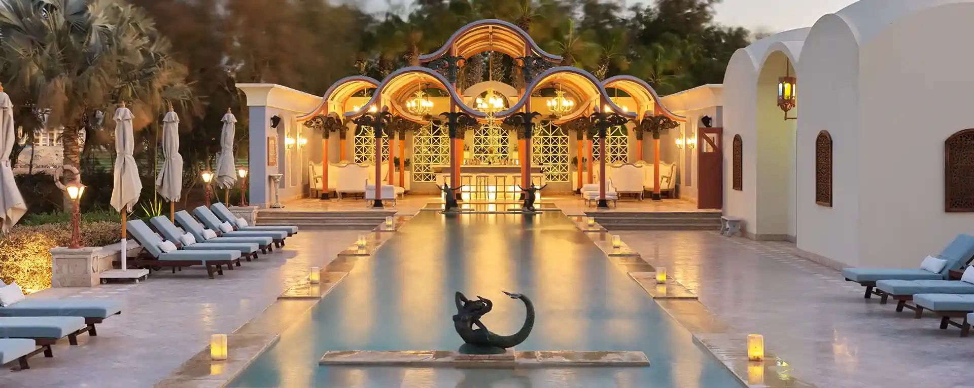 Relaxing poolside scene at La Maison Bleue el Gouna, with inviting lounge chairs.