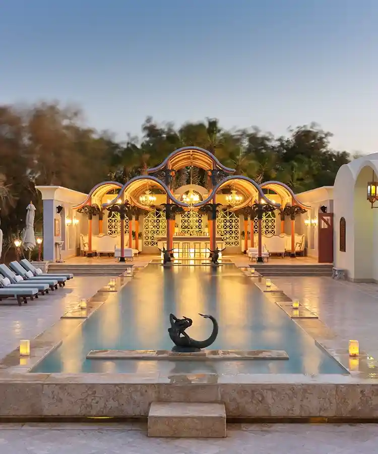 Relaxing poolside scene at La Maison Bleue el Gouna, with inviting lounge chairs.