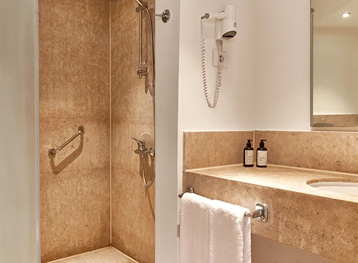 Closed bathroom at Captain's Inn, El Gouna, Red Sea, Egypt, featuring a modern and sleek design. The bathroom includes a spacious vanity, a large mirror, and contemporary fixtures, creating a clean and sophisticated space that offers privacy and comfort.