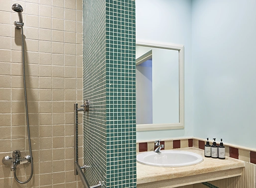Bathroom interior at Fanadir El Gouna, Red Sea, Egypt, featuring a sleek and modern design with a spacious vanity, a large mirror, elegant fixtures, and a walk-in shower, providing a clean and luxurious atmosphere.