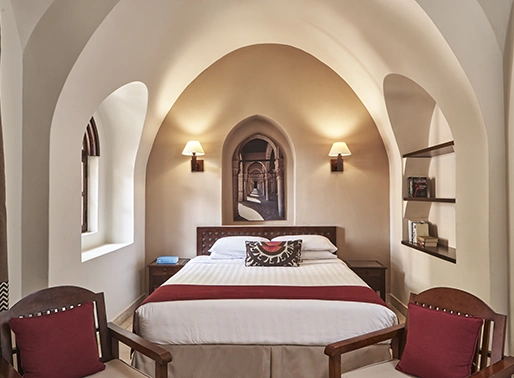 King bedroom at Red Sea, Egypt, featuring a luxurious king-sized bed with soft linens, stylish decor, and modern furnishings. The room is well-lit and designed for comfort, providing a relaxing and elegant space for guests to unwind.