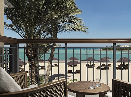 The terrace of The Chedi El Gouna Red Sea Beach Front room, overlooking the beach with comfortable seating and a view of the Red Sea.