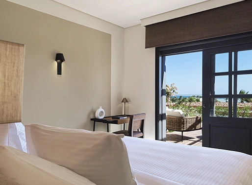 Superior Sea View King Room at Gouna Red Sea, featuring a luxurious king-sized bed with plush linens, a private balcony with breathtaking views of the Red Sea, and contemporary, elegant decor. The room is spacious and well-lit, designed to provide a relaxing and upscale experience with modern amenities.