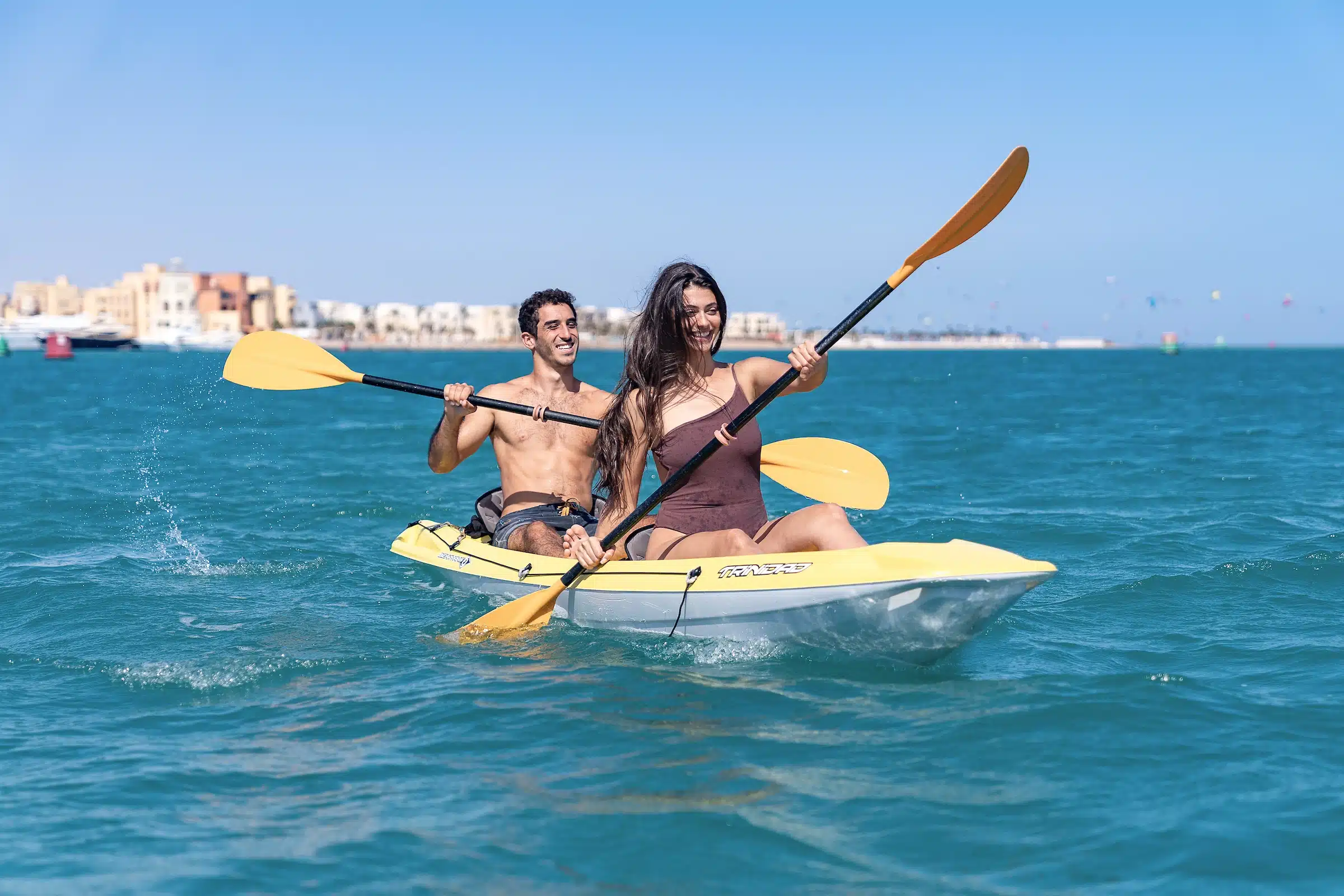 A couple kayaking on a small boat in the Red Sea